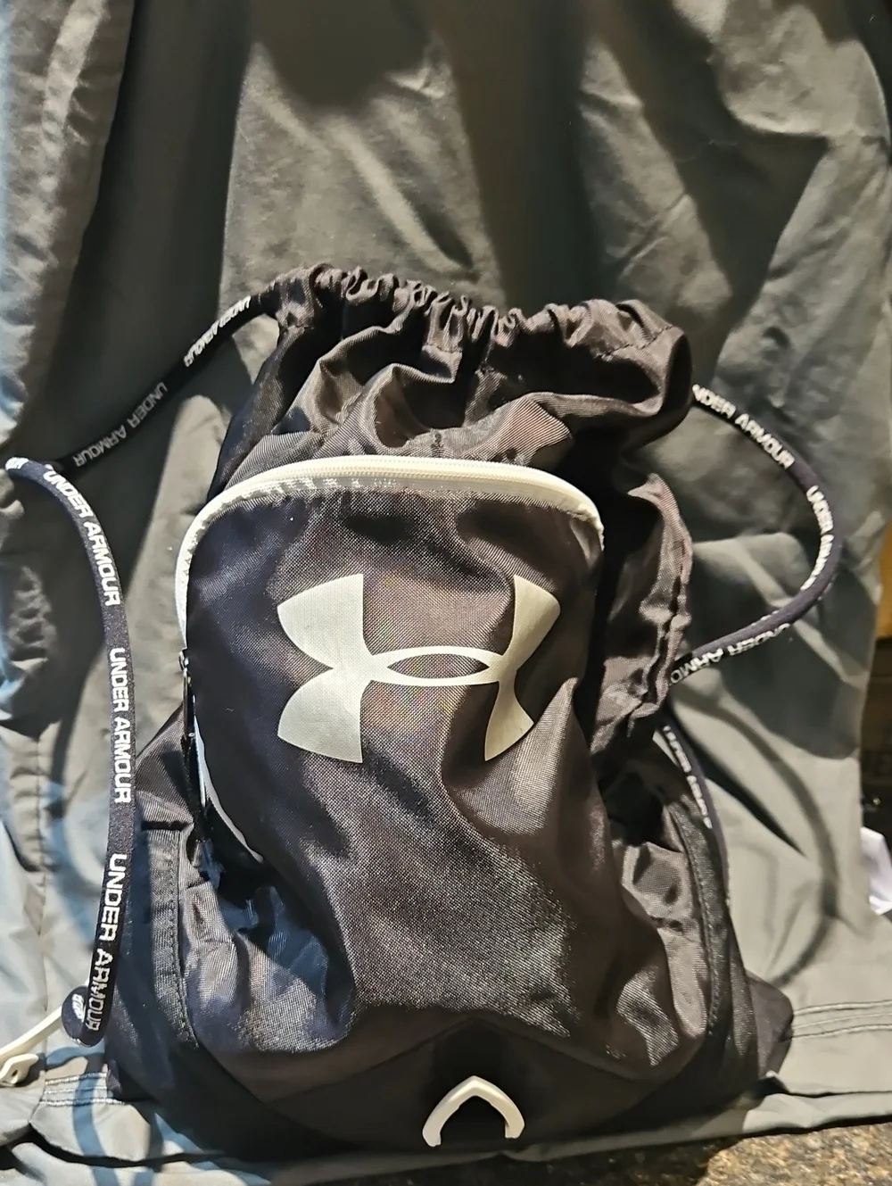 Under Armour Black Drawstring Backpack with White Trim and Front Pocket